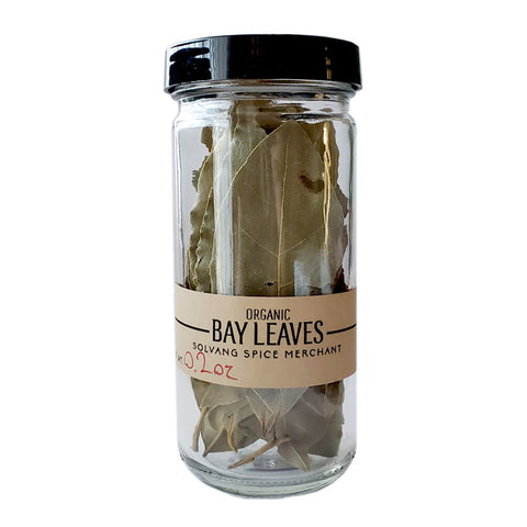 1 Cup Jar of organic bay leaves on white background