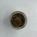 Small dish with loose pile of golden needles loose leaf tea