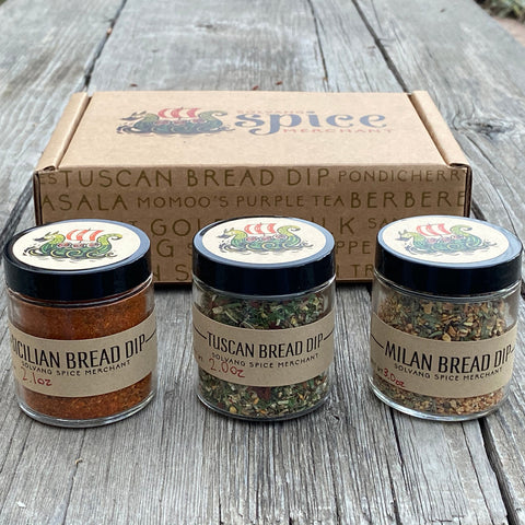 3 - 1/2 cup jars included in the Italian Bread Dip Gift Set siting in front of a gift box
