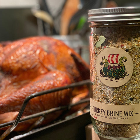 Jar of Turkey Brine next to roasted turkey